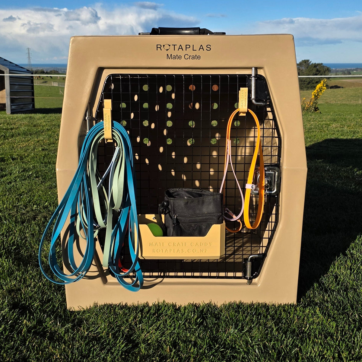Beige Dog Crate leash hooks and caddy attached to the door of a beige Rotaplas Mate Crate Mega with accessories attached
