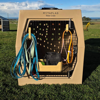 Beige Dog Crate leash hooks and caddy attached to the door of a beige Rotaplas Mate Crate Mega with accessories attached