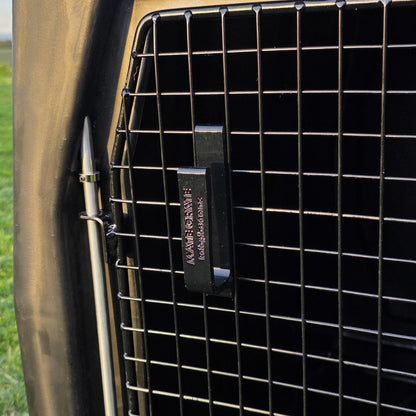 A black mate crate large dog leash door hook made to hold multiple long lines and leashed attached to the door of a mate crate
